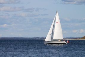 sailboat with denmark flag on sea