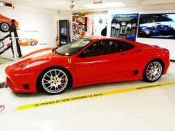 Side view of the red Ferrari at the exhibition