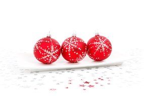 red balls with a pattern on the snow