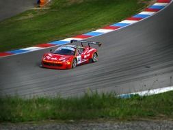 race car on the highway near the grass