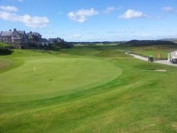 green golf course under blue sky