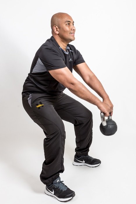 happy asian man making weight exercises