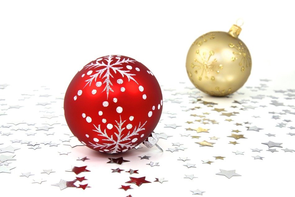 red and gold christmas balls on white table