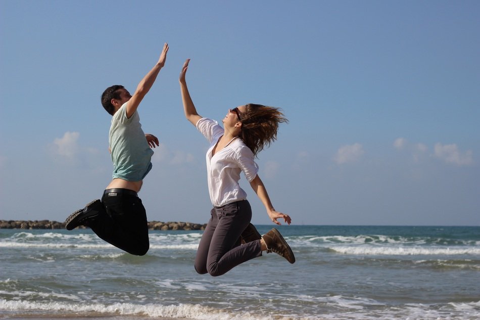 jump guy and girls on the coast