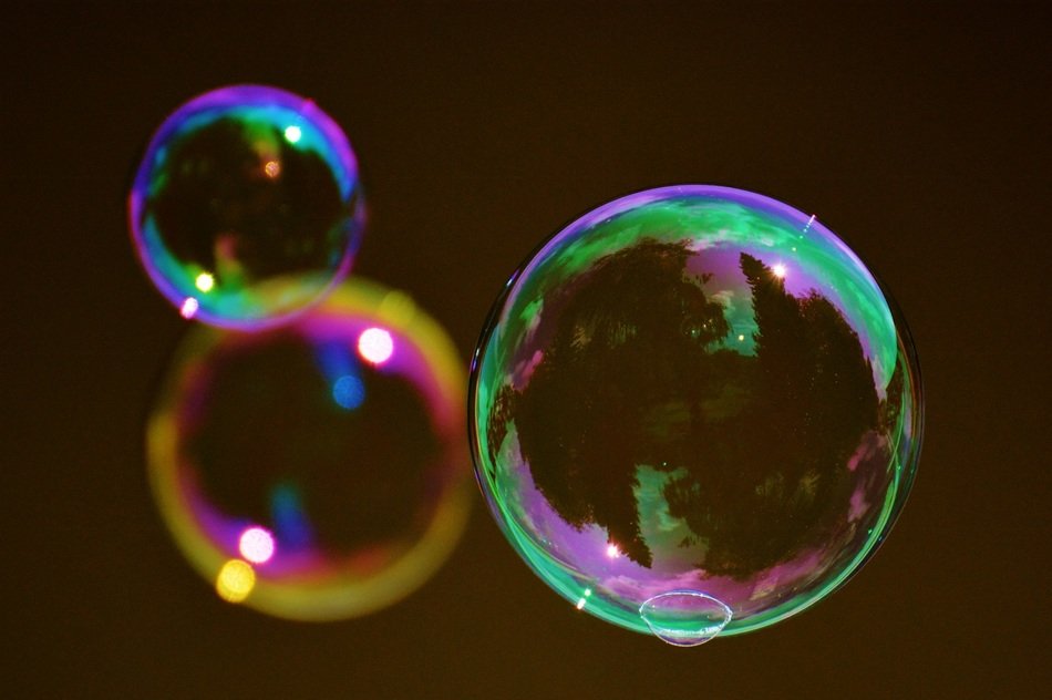 three soap bubbles on a brown background