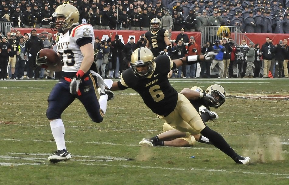 football players fall on the field