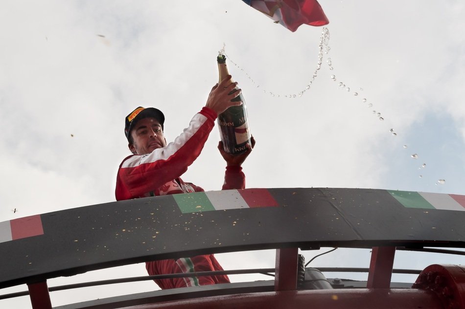 race car driver Fernando Alonso with champagne