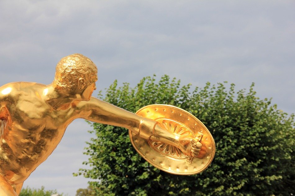 golden figure of the athlete in the park