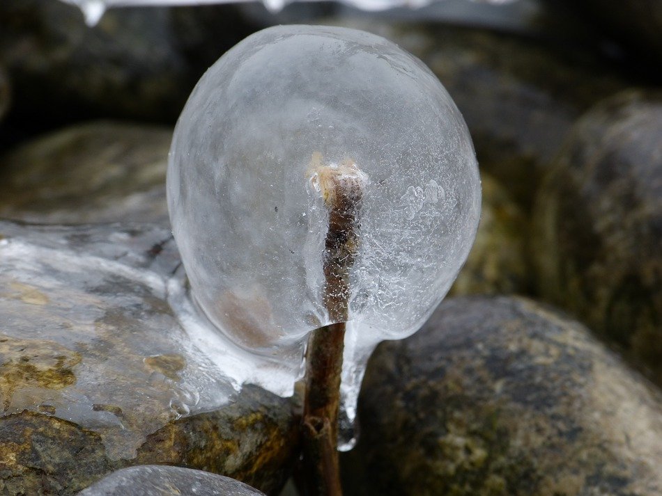 a piece of ice lies on the rocks in nature