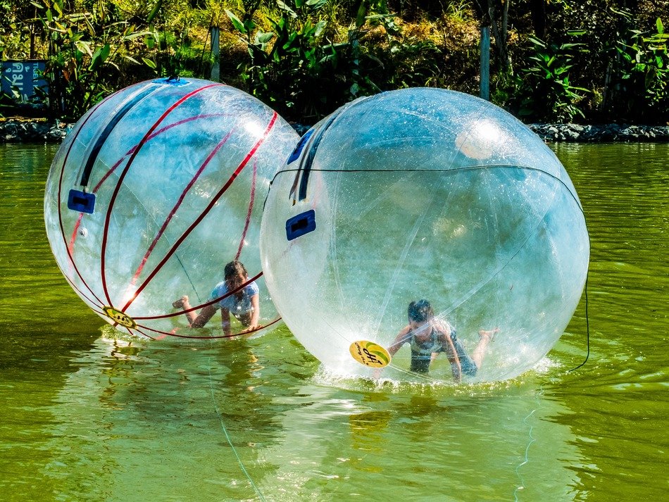people in ball on the water as extreme