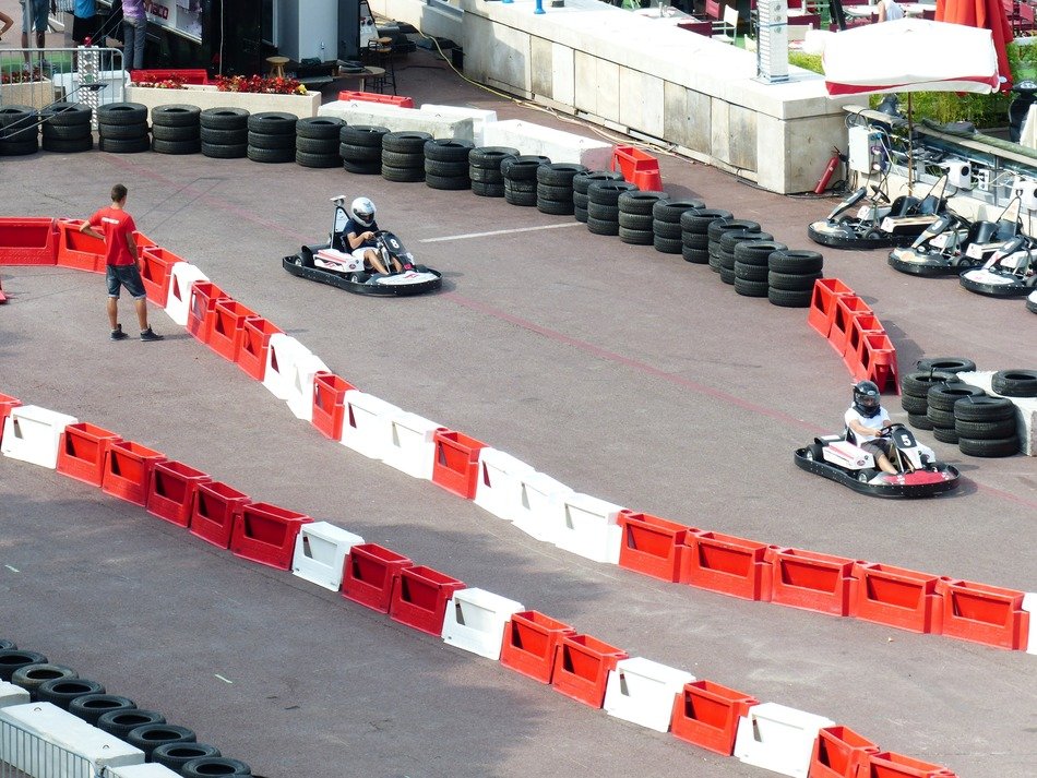kart drivers on fenced track