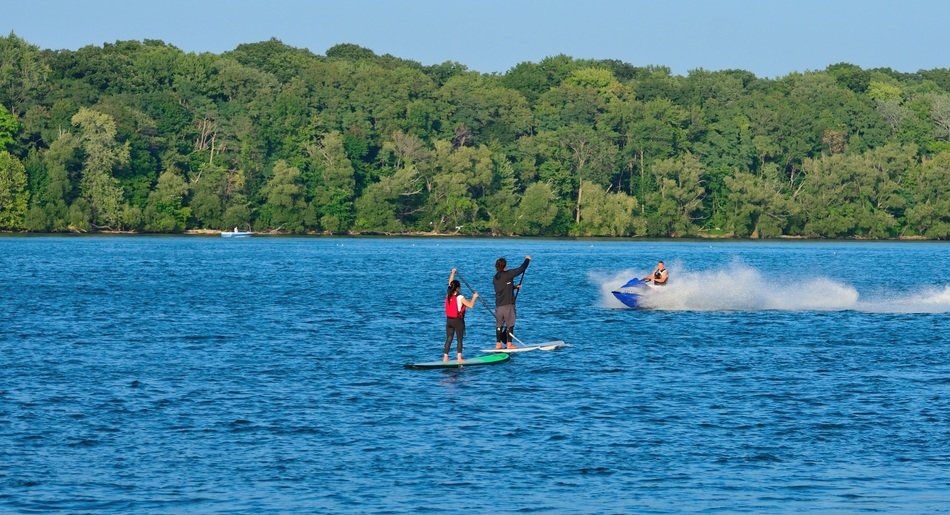 tourists on water boards sail along the Niagara River