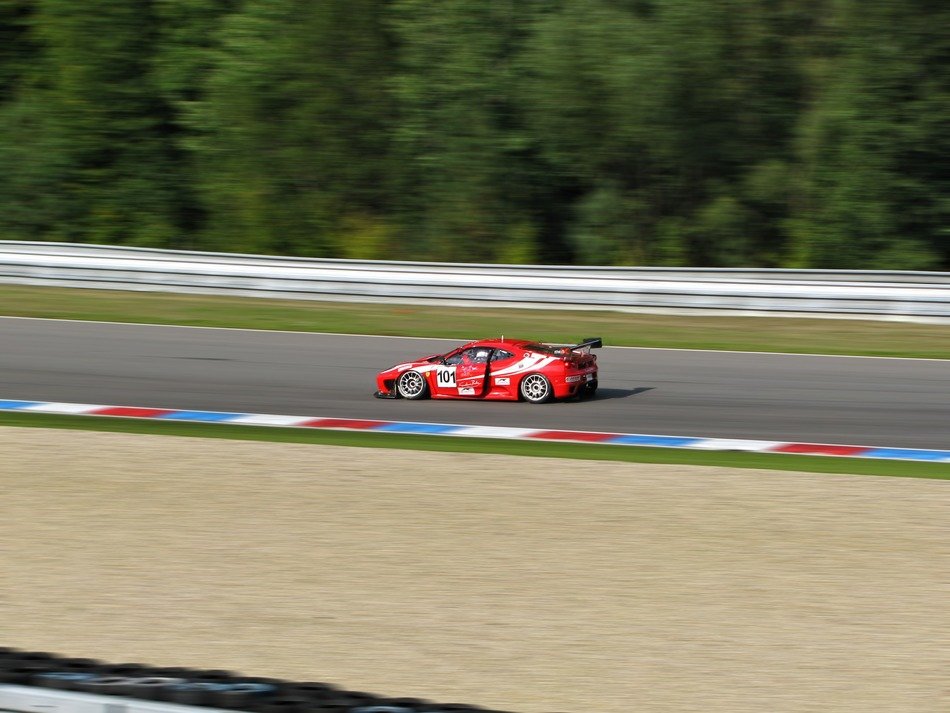red car speeds on the track