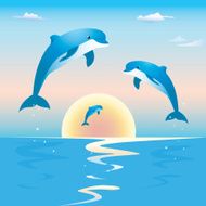 Jumping dolphins in front of a sunset over sea