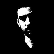 Serious male face illuminated in the dark