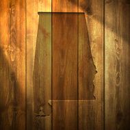 Alabama Map on lit Wooden Background