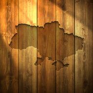 Ukraine Map on lit Wooden Background