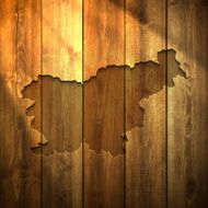 Slovenia Map on lit Wooden Background