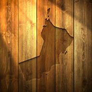 Oman Map on lit Wooden Background