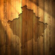 Kosovo Map on lit Wooden Background