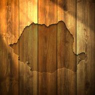 Romania Map on lit Wooden Background