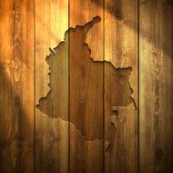 Colombia Map on lit Wooden Background