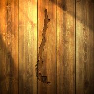 Chile Map on lit Wooden Background