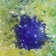 Splatter of blue purple paint on multi colored background