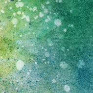 Colorful speckled background of watercolor and ink