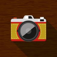 Vintage camera on wooden background and shadow
