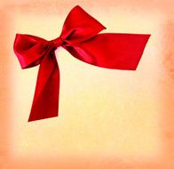 festive red bow on colored textured background - copy space