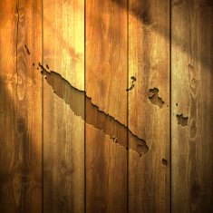 New Caledonia Map on lit Wooden Background