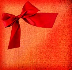 festive red bow on textured background - copy space
