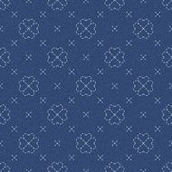 Embroidery with four leaf clovers on dark blue jeans background N2