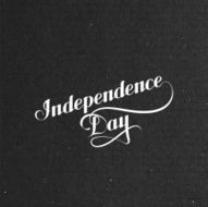 Independence Day label on black cardboard texture