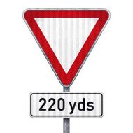 Blank triangular road sign with 220 yards ahead to hazard