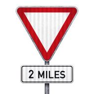 Blank triangular road sign with 2 miles ahead to hazard