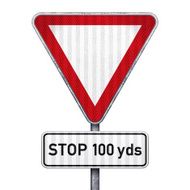 Triangular road sign with 100 yards ahead to stop
