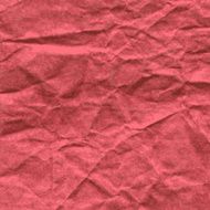 Background of crumpled paper in red color