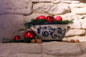 ceramic bowl with red christmas balls