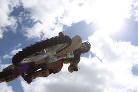 jumping motorcyclist on a cloudy sky background