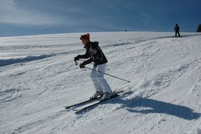 woman is skiing down the mountain