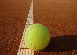 yellow tennis ball on the court