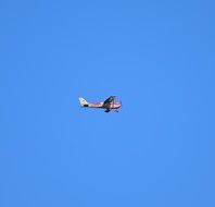 small plane in the blue sky