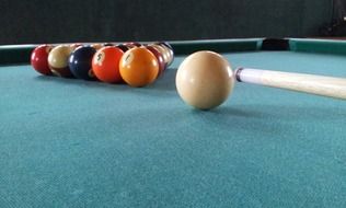 multi-colored balls on a table in billiards