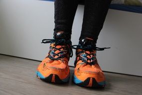 legs in orange sneakers