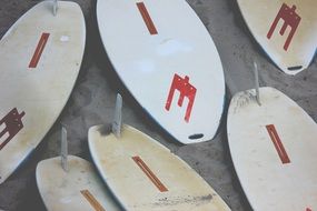 lot of surfboards in the sand