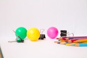 multicolored balls and stationery on the table