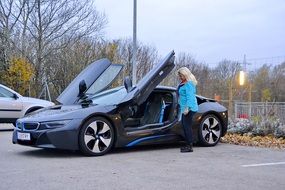 Woman near a sports car