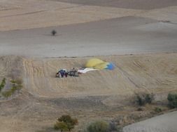 panoramic view of landing a hot air balloon in the field